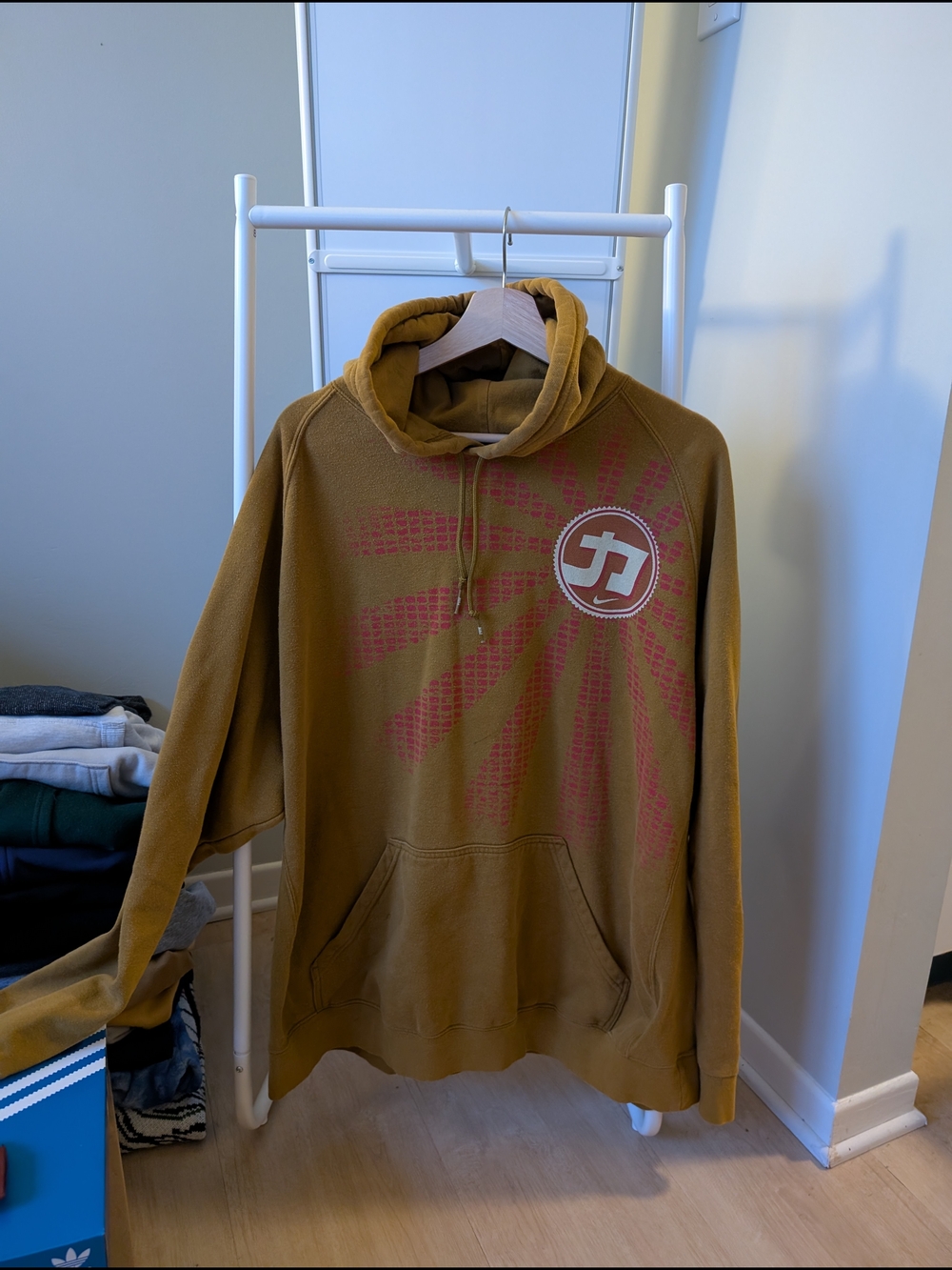 Brown Graphic Hoodie with Red Sunburst Logo